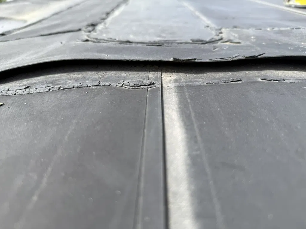 Flat commercial roof with completed patch work visible