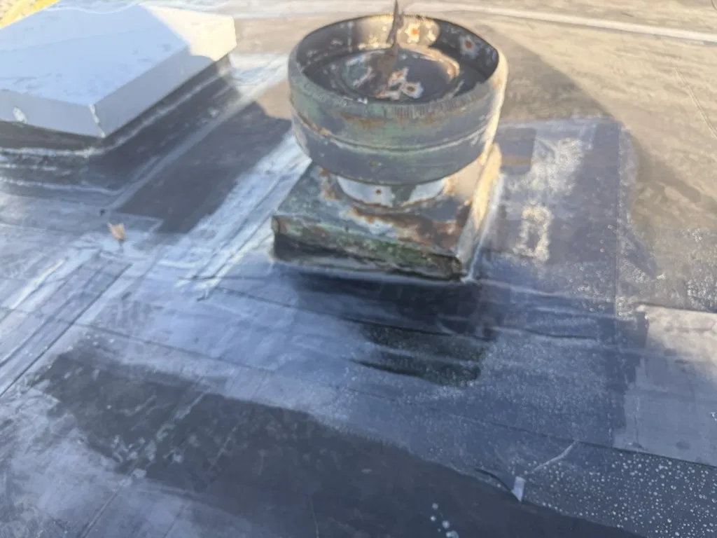 Commercial roof transition area sealed with patch material