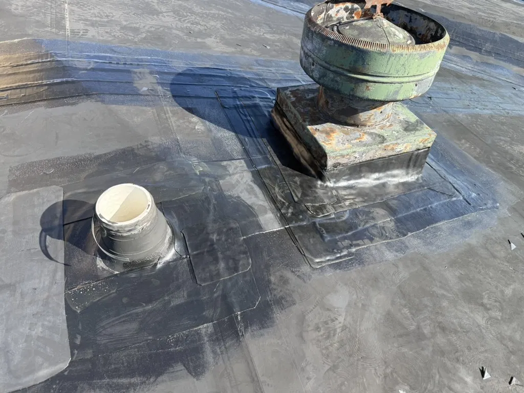 Commercial roof flashing patch at a wall transition