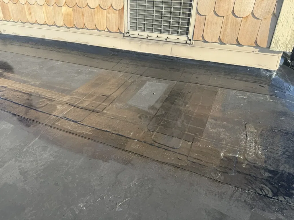 Pipe boot and penetration sealed on a flat roof